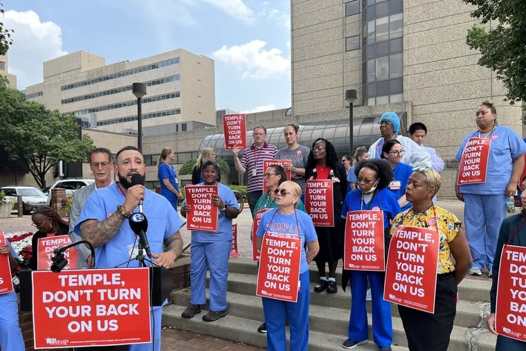 Carlos Aviles, a pharmacy tech at Temple University Hospital, speaks at a rally in opposition of moving occupational health services from the main North Broad Street campus.
