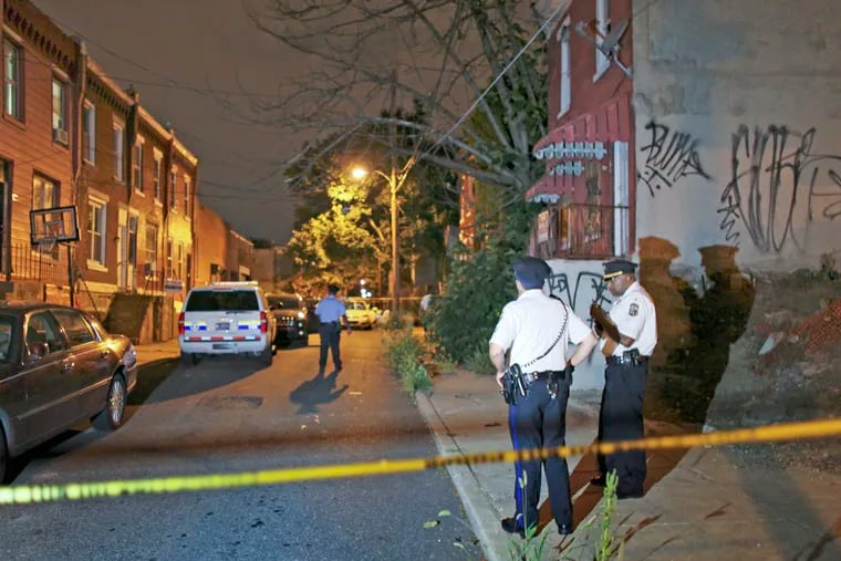 Investigators gather on Manton Street near South 25th Street in the King Village section of South Philadelphia on Thursday Aug. 21, 2014.  For the Daily News/ Joseph Kaczmarek