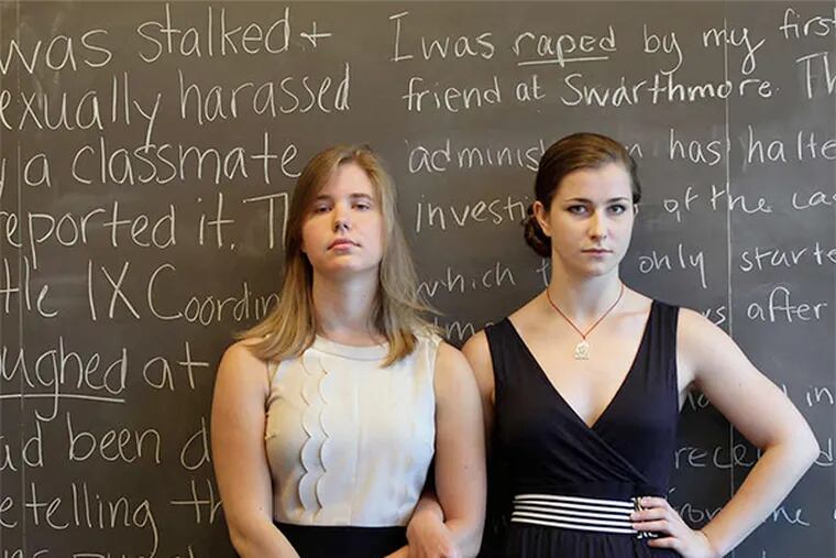Leading voices in the Swarthmore controversy, Hope Brinn (left) and Mia Ferguson, stand in front of the blackboard where they have written their stories about sexual assault at the school.
