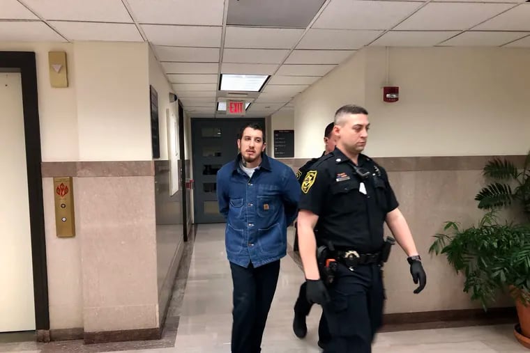 Steven Dougherty is escorted out of a courtroom in Montgomery County on Wednesday after pleading guilty to aggravated assault and endangering the welfare of a child.