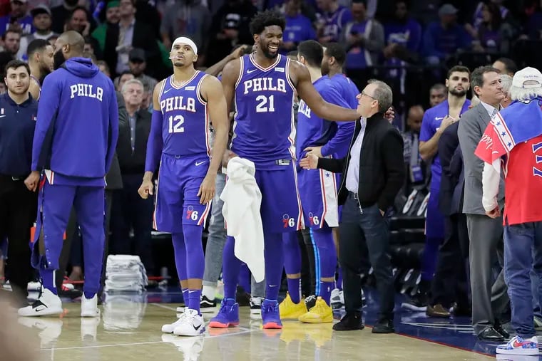 Sixers star Joel Embiid (21) smiles with majority partner Josh Harris during a game in October 2019.