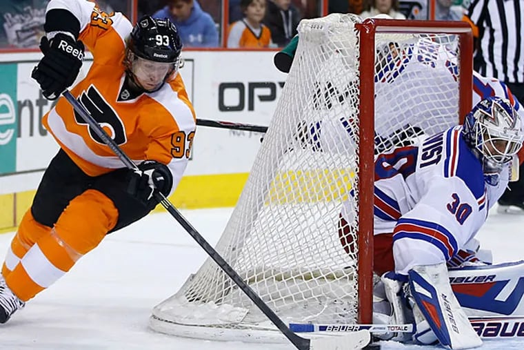 Rangers' Henrik Lundqvist, right, blocks a shot by Flyers' Jakub Voracek. (Matt Slocum/AP)