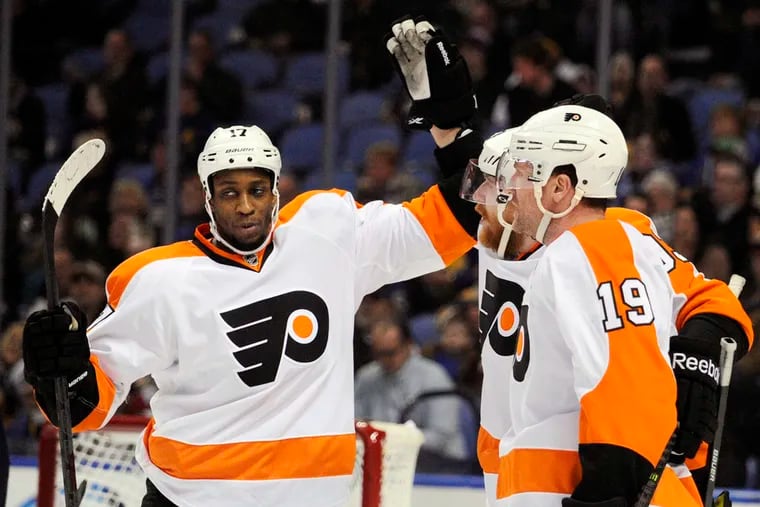 Philadelphia Flyers'  Wayne Simmonds, left celebrates with Jakub Voracek , center, and Scott Hartnell, right, celebrate after a goal by Voracek during the second period of an NHL hockey game against the Buffalo Sabres in Buffalo, N.Y., Tuesday, Jan. 14, 2014. (AP Photo/Gary Wiepert)