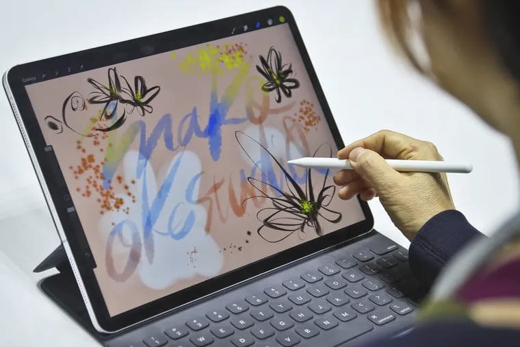 Japanese artist Mako Oke draws on the new iPad Pro using its pencil accessory after an event announcing new products Tuesday, in the Brooklyn borough of New York.