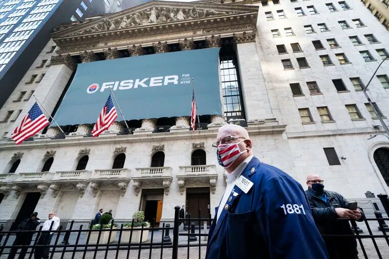 Stock trader Thomas Ferrigno arrives to work at the New York Stock Exchange, Monday, Nov. 9, 2020. World markets rocketed higher after Pfizer said early data show its coronavirus vaccine is effective.