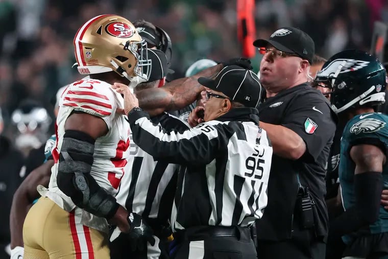 San Francisco 49ers linebacker Dre Greenlaw points at Eagles Chief Security Officer Dom DiSandro in the third quarter on Sunday, December 3, 2023 in Philadelphia.  The two were ejected from the game.