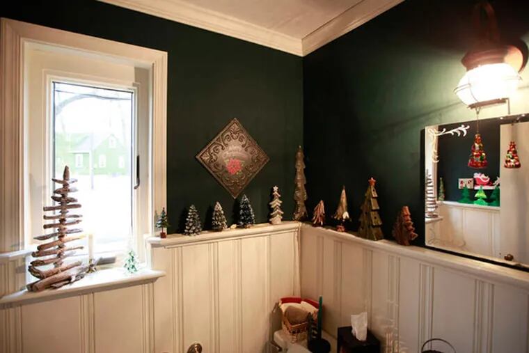 Yuletide trees of all shapes and sizes line the chair rail of the Barrs' home. Every item in the couple's vast Christmas collection prompts a memory - figurines from friends and relatives, tokens from trips, mementos from their childhoods.