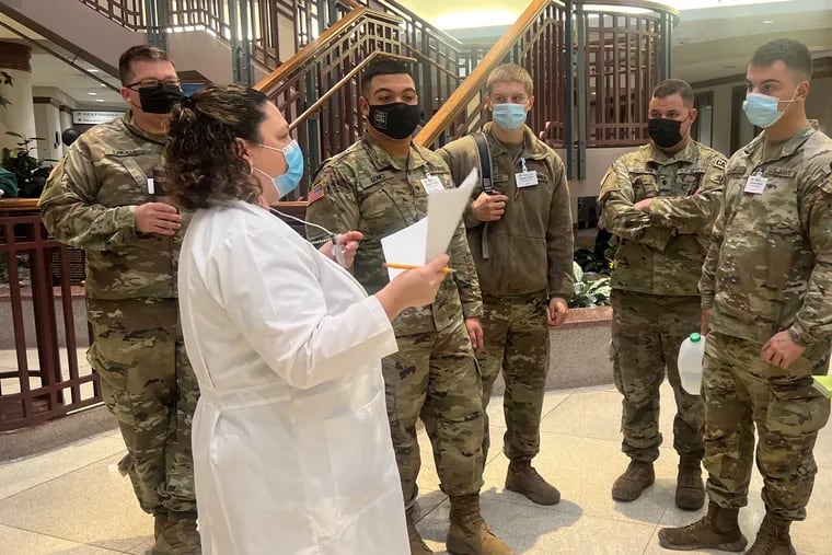 Brenda Disabatino, a nurse manager at ChristianaCare’s Christiana Hospital in Newark, talks to a team of National Guard members who arrived Tuesday Jan. 11 to help with COVID-19 response.