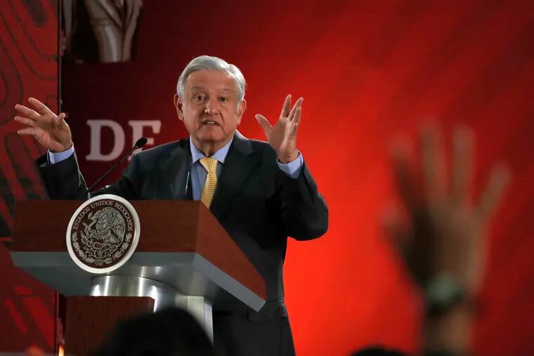 In this Friday, March 8, 2019 photo, Mexican President Andres Manuel Lopez Obrador answers questions from journalists at his daily 7 a.m. press conference at the National Palace in Mexico City. Lopez Obrador's first 100 days in office have combined a compulsive shedding of presidential trappings with a dizzying array of policy initiatives, and a series of missteps haven't even dented his soaring approval ratings. (AP Photo/Marco Ugarte)