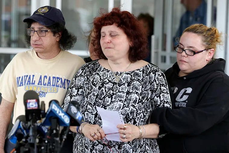 Howard Zemser (left) and wife Susan (center), parents of Naval Academy midshipman Justin Zemser, discuss the loss of their son. (SETH WENIG / ASSOCIATED PRESS)