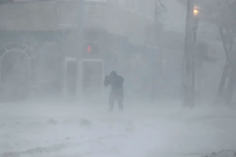 A man struggles to cross an Atlantic City street during the bomb cyclone that brought snow and high winds to the region four years ago.