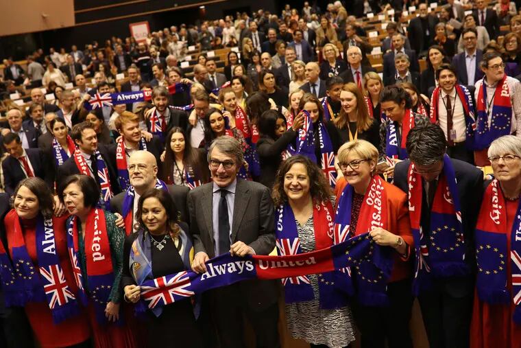 European Parliament President David Sassoli, center, stands with other British MEP's and members of the political group Socialist and Democrats as they participate in a ceremony prior to the vote on the UK's withdrawal from the EU at the European Parliament in Brussels.