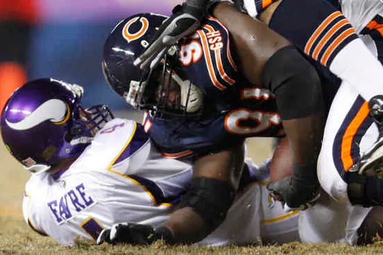 Bears' Tommie Harris recovers fumble by Vikings QB Brett Favre in the first quarter of last night's game, which ended too late for this edition. Find out who won on philly.com/philly/sports.