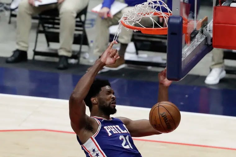 Sixers center Joel Embiid gets his finger caught in the net after a second quarter dunk against the Washington Wizards in Game 3 of their first-round playoff series in Washington D.C., on Saturday, May 29, 2021.