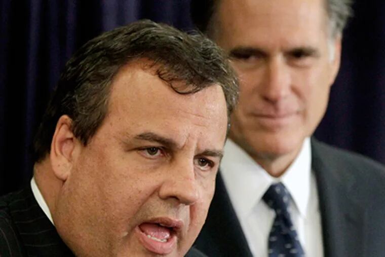 Gov. Christie delivers his endorsement of GOP presidential candidate Mitt Romney (right) in New Hampshire. Christie criticized Romney rival Rick Perry for his association with a pastor who called Mormonism a cult. (AP Photo/Stephan Savoia)