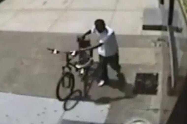 A frame from a surveillance video shows the thief leaving with the officer’s bicycle.