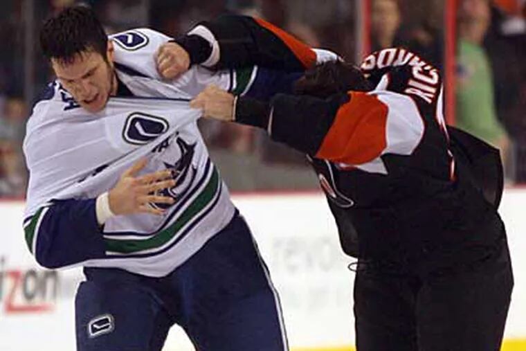 Flyers' Mike Richards and Vancouver Canucks' Kevin Bieksa (left) fight
during the second period on Thursday, December 3, 2009.  (Yong Kim /
Staff Photographer)