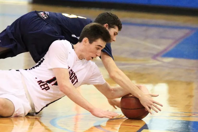 Shane Cohen, top, of Lower Moreland and Jack Elliott of Holy Ghost Prep scramble for a loose ball in the 2nd quarter on Jan 16, 2018.