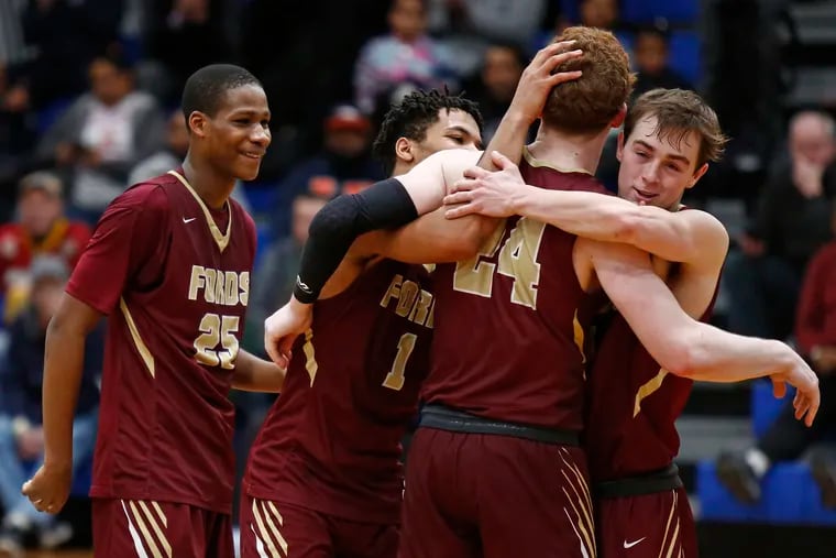 Christian Ray (24) is congratulated by teammates (from left) Jameel Brown, Jameer Nelson and Gavin Burke after setting a Haverford School record for career points (1,578) during the fourth quarter against Camden in a Winter Classic basketball game Saturday, Feb. 9, 2019, at Paul VI. Haverford went on to win, 51-46. LOU RABITO / Staff