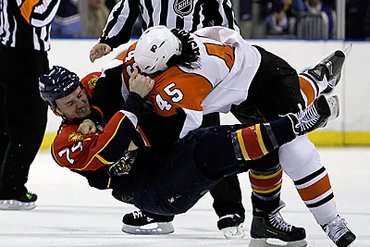 Panthers center Nick Tarnasky (74) fights with Arron Asham (45) in the first period during. (AP Photo/Lynne Sladky)