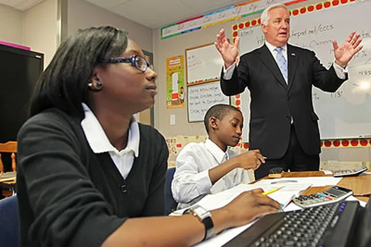 Gov. Tom Corbett, right, talks to a 6th grade enrichment class about mathematics while Chester Community Charter School students Essence Goodwin, 12, left, and Fasaad Johnson, 12, center, listen intently. (Michael Bryant / Staff Photographer)