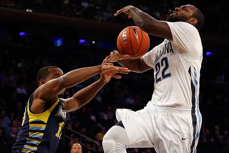 Villanova's JayVaughn Pinkston gets fouled by Marquette's Derrick Wilson during the first half in the Big East quarterfinals on Thursday, March 12, 2015 at Madison Square Garden in New York. (Yong Kim/Staff Photographer)
