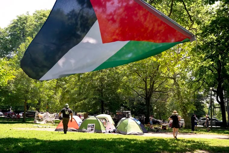 A Palestinian flag hangs at a tent encampment Wednesday that was set up in Clark Park in West Philadelphia.