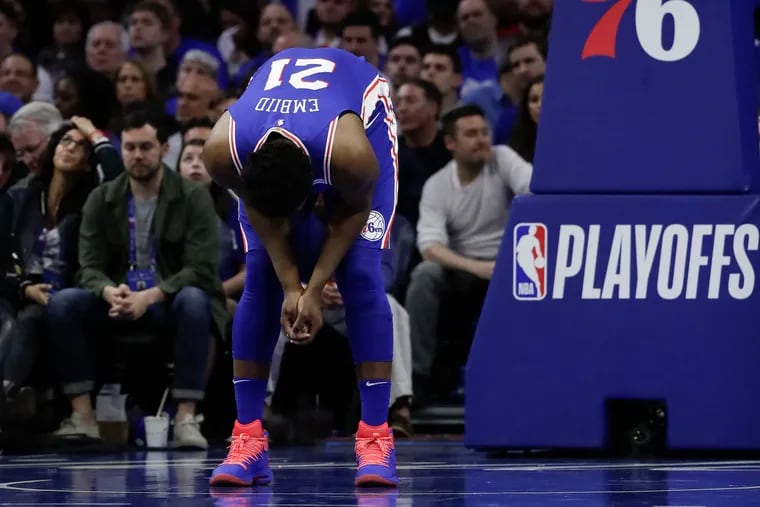 Sixers center Joel Embiid bows down during a third-quarter break in action against the Brooklyn Nets in game one of the Eastern Conference playoffs on Saturday, April 13, 2019 in Philadelphia.  The Nets beat the Sixers 111-102 in game one.