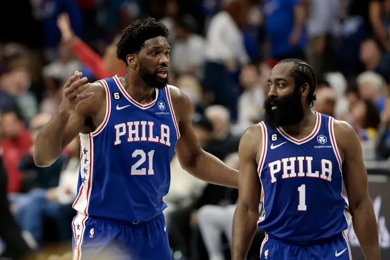 Sixers stars Joel Embiid (left) and James Harden talk as they head to the bench Sunday during Game 4 of the Eastern Conference semifinals against the Celtics.
