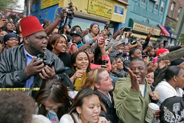 Members of the audience outside the Uptown Theater on North Broad Street angle for a better view of the music-industry royalty on stage.