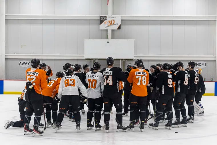 Players huddle up to go over drills on the first day of Flyers rookie camp in Voorhees on Thursday.