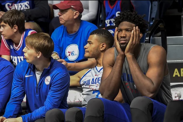 Joel Embiid (right) watching last year's scrimmage at the Palestra.