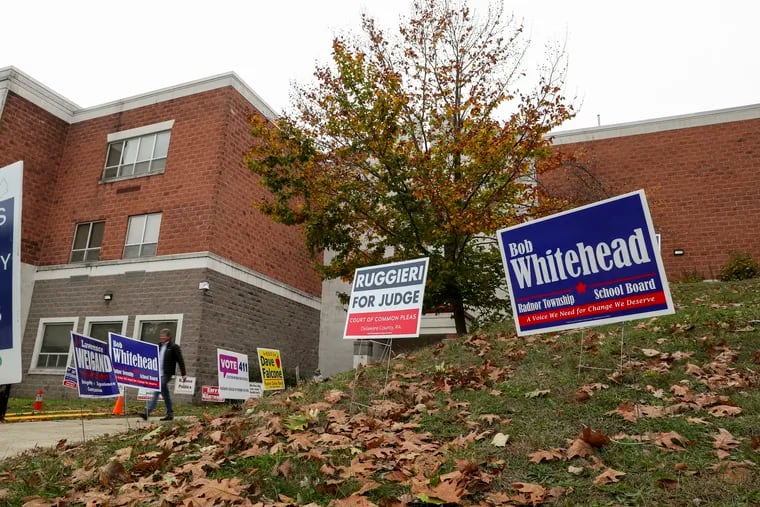 Political signs line the sidewalk on Election Day at Radnor High School in Wayne. Democrats on the Radnor school board appeared to hold onto their seats, fending off a challenge from Republicans backed by a statewide PAC.