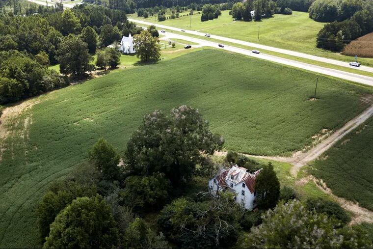 A farmhouse is surrounded by soybean fields in Locust Hill, Va. The U.S. and China have imposed import taxes on $50 billion worth of each other's products. Caught in the crossfire are U.S. soybean farmers, a prime target of Beijing's retaliatory tariffs, whose exports to China account for about 60 percent of their overseas sales.