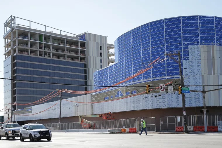 An unidentified worker crosses Packer Avenue as work continued at the future site of Live! Hotel and Casino Philadelphia on April 6, 2020. It was shut down days later, according to city officials.
