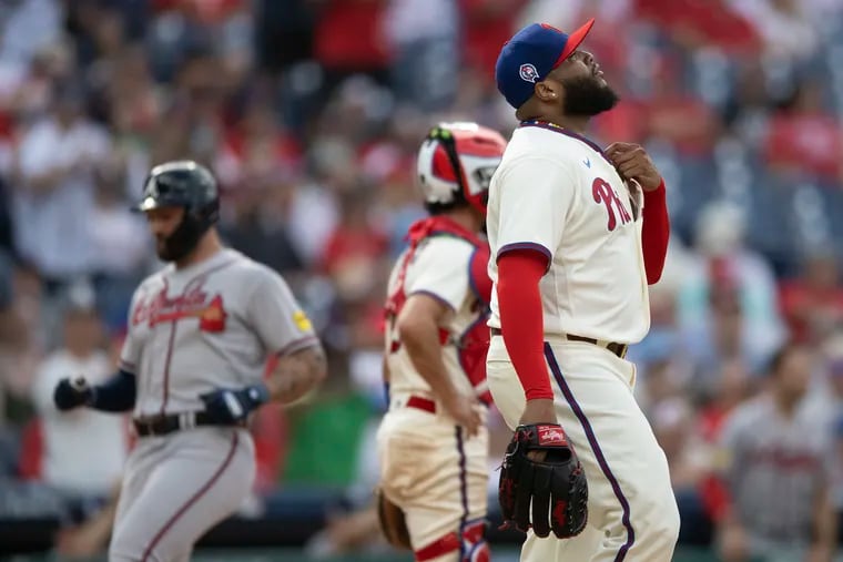 Philadelphia Phillies' Jose Alvarado, right, reacts after allowing two runs in extra innings against The Atlanta Braves in a doubleheader, Monday, Sept. 11, 2023, in Philadelphia.