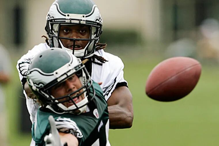 Trevard Lindley (back) defends Riley Cooper during a training camp drill. (Yong Kim/Staff Photographer)
