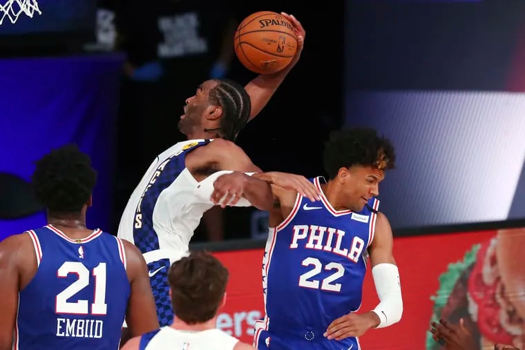 76ers guard Matisse Thybulle (22) fouls Indiana Pacers forward T.J. Warren, who grabs a rebound during the third quarter Saturday.