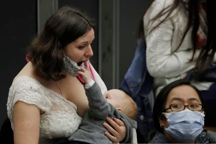 Valentina Frey of Switzerland breasts feed her daughter, Charlotte Katharina, in the Paul VI hall on the occasion of the weekly general audience at the Vatican. Released on Tuesday, Dec. 29, 2020, the first U.S. government dietary guidelines for infants and toddlers recommend exclusive feeding of breast milk for at least six months and no added sugar for children under age 2.