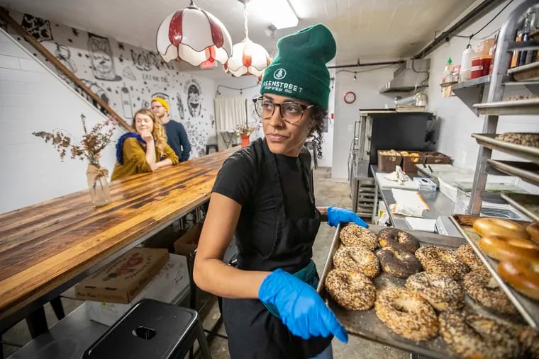 Sarah Thompson, of Tall Poppy Bagels, pulls a pan of bagels out in anticipation of the crowd that will come down to the “pop down” at Liberty Kitchen on Sunday, January 26, 2020. She sent a notice out on Instagram that she would be selling bagels on Sunday morning and fans of her bagels showed up to buy them.