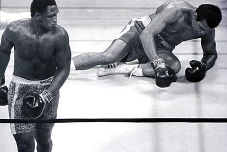 Joe Frasier heads to a neutral corner after knocking down Muhammad Ali. (Elwood P. Smith/Staff File Photo)