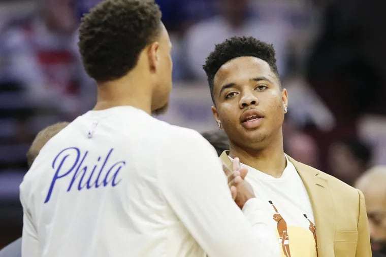 Sixers guard Markelle Fultz (right) talking to teammate Justin Anderson during a game in early February.