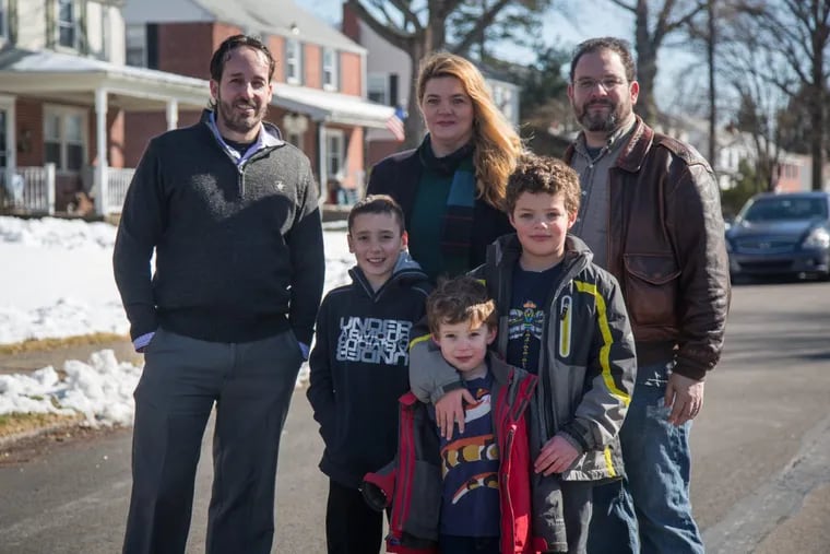 Chris Hatton (left) and his son Charlie, 8, stand with Sam Soldan and her husband, Jonathan Fingerut, and sons Xander, 5, and James, 8. Both families have been told they did not win after-school-care slots for their elementary school children this fall.