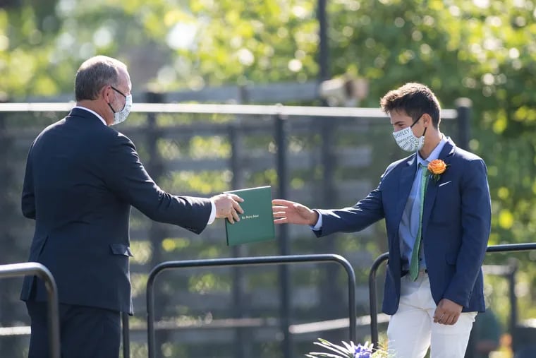 Head of School Michael Turner hands a diploma to graduating student Jordan Kaliner at a coronavirus-delayed commencement ceremony at The Shipley School in Bryn Mawr, Pa., on Aug. 1, 2020.