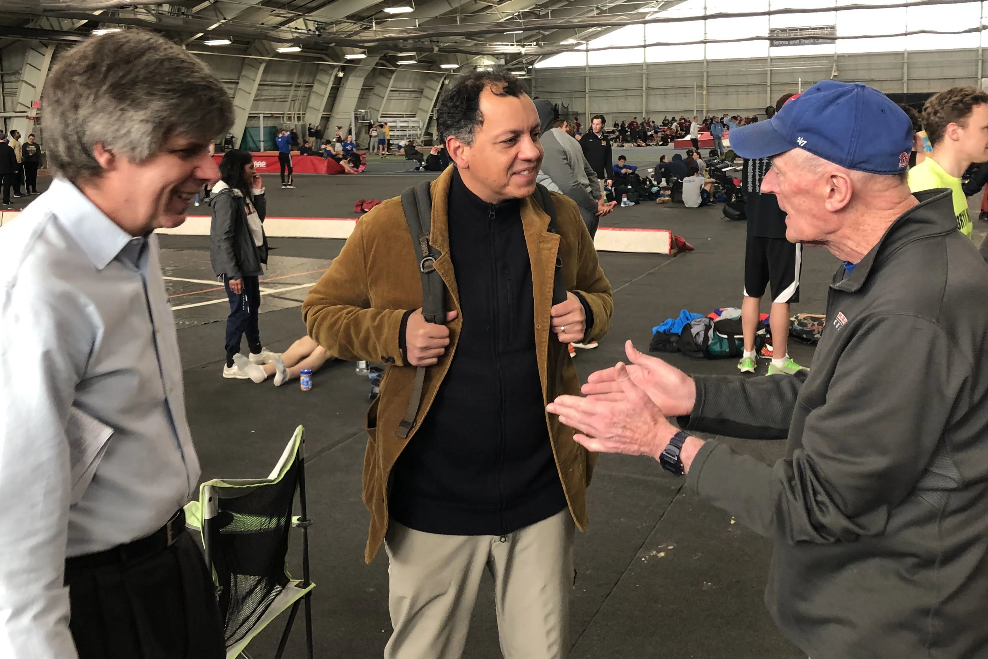 Haverford track coach Tom Donnelly (right) with former assistant Michael McGrath (left) and Robard Williams, who still holds five school records set in the late 1980s.