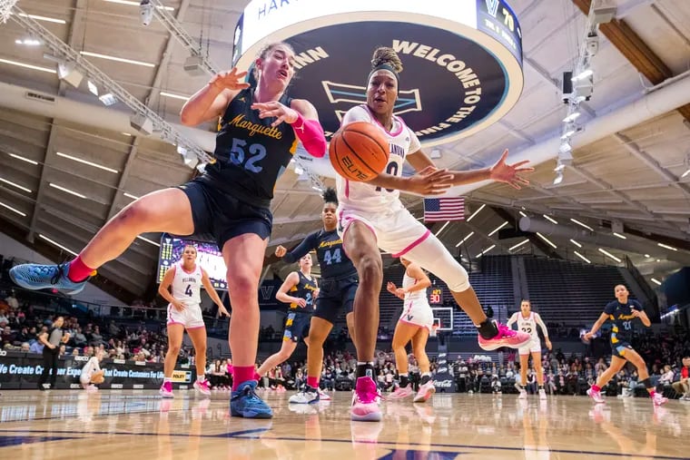 Christina Dalce (right)  of Villanova and Chloe Marotta of Marquette go after a loose ball during the 2nd half on Feb. 1, 2023 at the Finneran Pavilion at Villanova University. The game also celebrated National Girls and Women in Sports Day.