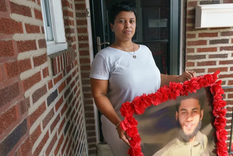 Tamika Morales holds a photograph of her son, Ahmad Morales, who was murdered over July 4th weekend, in Philadelphia, July 20th, 2020.