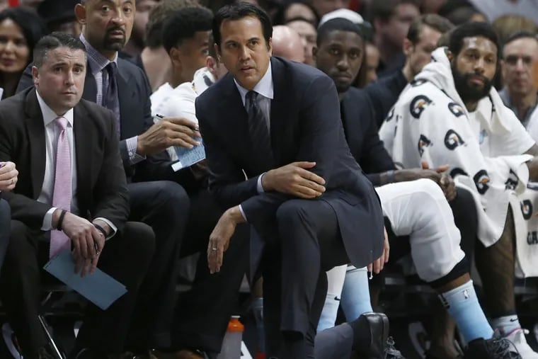 Miami Heat head coach Erik Spoelstra kneels by the bench as he watches during the first half of an NBA basketball game between the Heat and the Charlotte Hornets, Saturday, Jan. 27, 2018, in Miami.