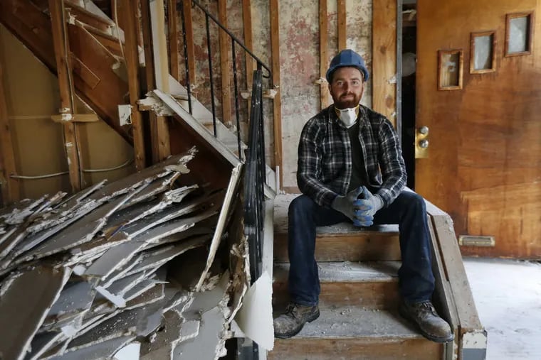 Greg Trainor, founder of Philadelphia Community Corps is pictured in a property along Kimball Street in Philadelphia, Pa. His group removes still-intact construction materials that can be re-used at other sites.