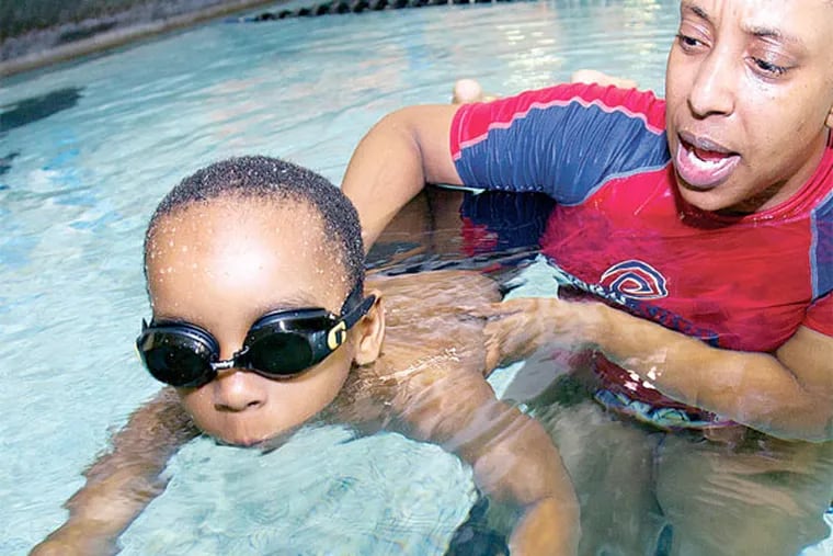 Anysha Carney is a swim instructor dedicated to teaching African-American children how to swim. She is shown with her 5-year-old son Cyndall Carney-Jacobs. ( ALEJANDRO A. ALVAREZ / STAFF PHOTOGRAPHER )